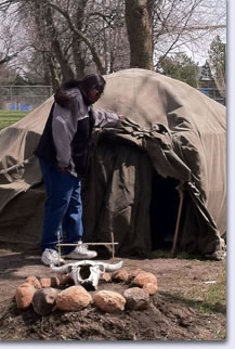 Photo of a man standing in front of a tent